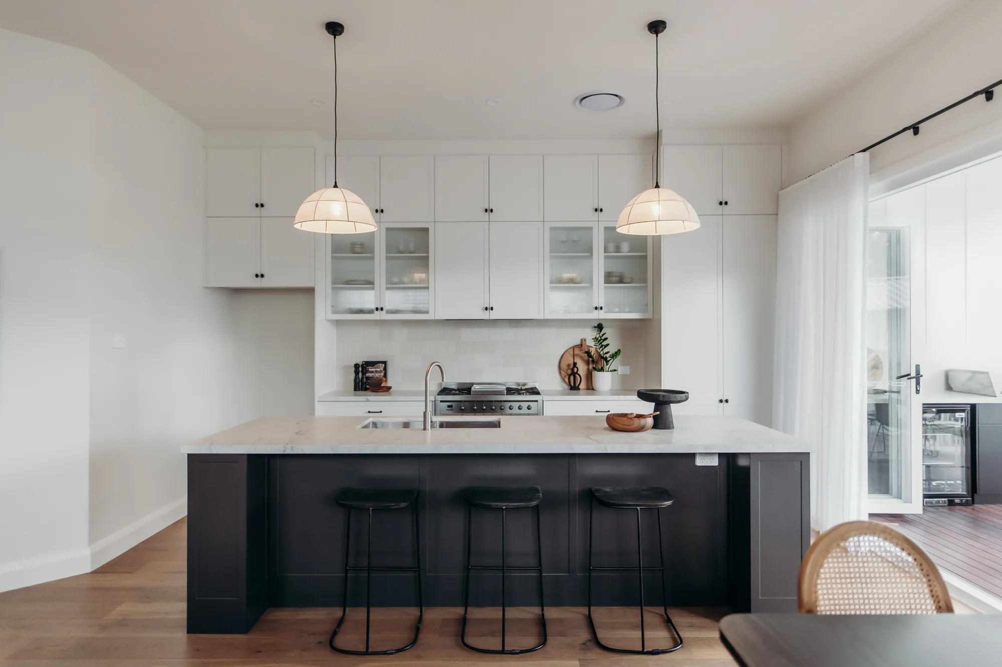 Mayfield: brushed stone over a black island, with Garry Jeans Kitchens